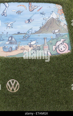 Eco transporter van covered in Astro turf and with wooden Volkswagen Badge and grill Stock Photo