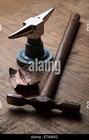 Metal forming tools and forged copper work. Stock Photo
