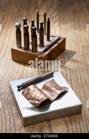 Metal doming punches and copper chased work. Stock Photo