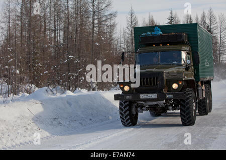 Old Russian truck on snow ice road trees Stock Photo