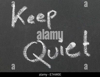 Keep Quiet written in a black board by white chalk Stock Photo