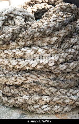 Detail of coiled rope on quayside Stock Photo