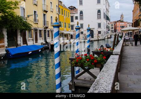 Italy Venice Zattere Rio di San Vio gondolas  plus the famous white  and blue mooring  poles Stock Photo