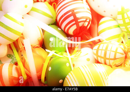 many colorful easter eggs in a nest as decoration Stock Photo