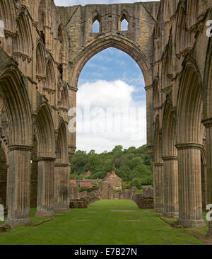 View through high archway at picturesque ruins of historic 12th century Rievaulx abbey, Cistercian monastery - Yorkshire England Stock Photo