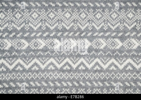 Knit fabric background with knitted grey and white geometric pattern Stock Photo