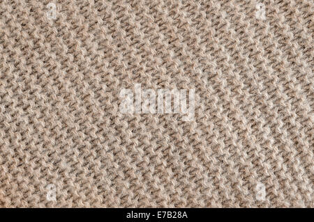 Knit texture of undyed brown alpaca wool knitted fabric with diagonal garter stitch pattern as background Stock Photo