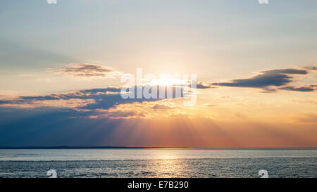 Sunset and sunbeams with dramatic sky over Atlantic Ocean in Prince Edward Island, Canada Stock Photo