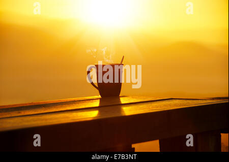 Silhouettes on sunrise morning coffee. Stock Photo