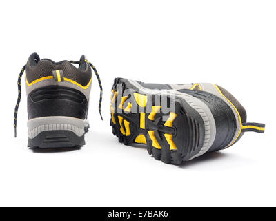 One pair of grey and yellow walking boots isolated on white background Stock Photo
