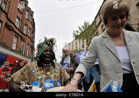 Stirling, Scotland, UK. 12th September 2014. Nicola Sturgeon, a minister for SNP, visits Stirling to raise support for Scottish Independence.  A local man known as 'Bongo Terry' who is know for playing the bongos in the area shows his support for independence. Nicola Sturgeon had a shot of the bongo. Credit:  Andrew Steven Graham/Alamy Live News Stock Photo