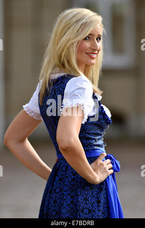 Young woman wearing a blue dirndl Stock Photo
