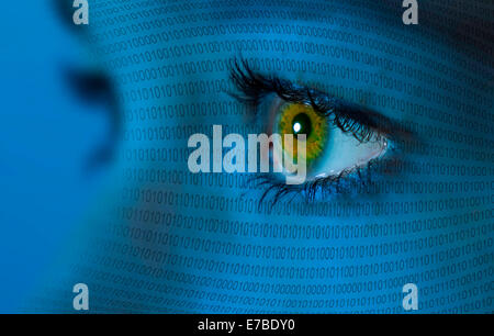 A woman&#39;s eye and binary code Stock Photo