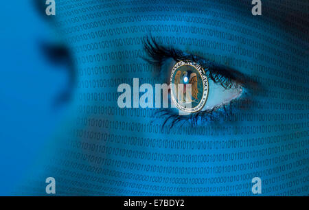 NSA logo in a woman's eye and binary code Stock Photo