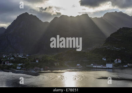 Sun rays breaking through the clouds over the mountains of the municipality of Moskenes, Lofoten, Nordland, Norway Stock Photo