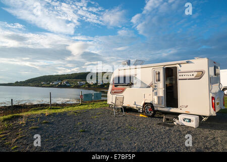 A Bailey Seville Caravan parked on a lakeside pitch by Loch Dunvegan Isle of Skye Scotland in golden evening sunshine Stock Photo