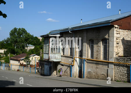 An elderly woman walks past a house with the harvest from her garden in Shusha in the Armenian region  Nagorno-Karabakh on 25 June 2014. Yellow gas pipes supported by blue poles are seen in front of the building. The Nagorno-Karabakh Republic is a de facto independent but unrecognized state disputed between Armenia and Azerbaijan. The landlocked region in the South Caucasus is inhabited by Armenians. Photo: Jens Kalaene -NO WIRE SERVICE-