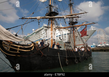 Tall ship Phoenix docks in front of the adventure of the seas cruise ship at the Southampton boat show 2014. Stock Photo