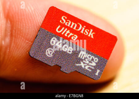 A SanDisk Ultra 64GB MicroSD XC card for use in Smartphones on a fingertip Stock Photo