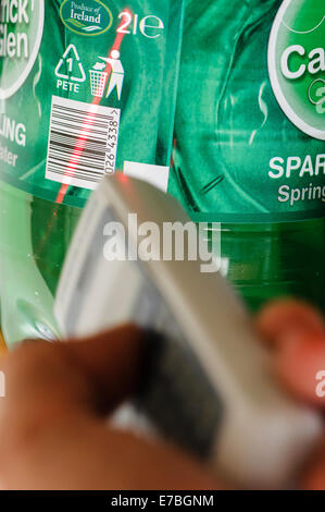 A man uses a handheld barcode scanner Stock Photo