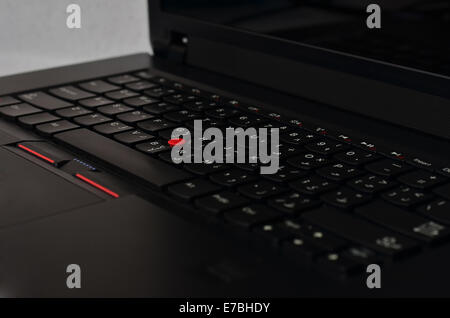 Black laptop keyboard with red track ball Stock Photo