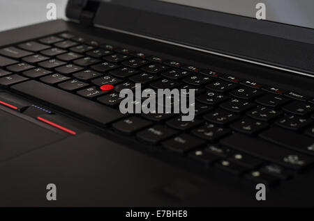 Black laptop keyboard with red track ball Stock Photo