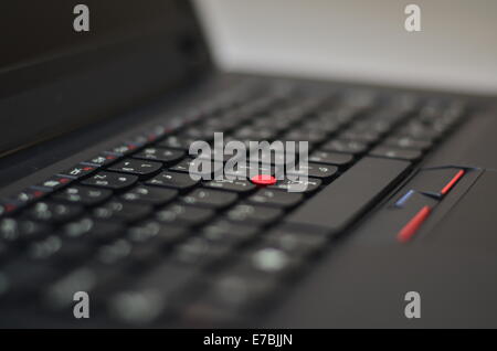 Black laptop keyboard with red track ball Stock Photo