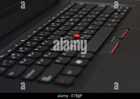 Black laptop keyboard with red track ball Stock Photo