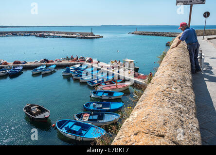 Looking down on the inner fishing harbour in the old town of Gallipoli, Puglia, Southern Italy. Stock Photo