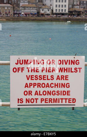 tourist resortA sign about diving and jumping, on Smeaton's pier, St Ives, Corwall, England, UK Stock Photo