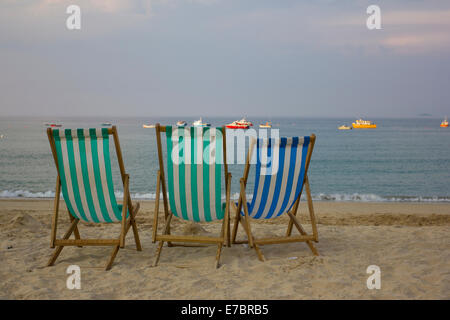 Three deck chairs on Porthmeor beach at sunset, St Ives, Cornwall, England, UK Stock Photo