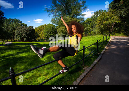 Young Brunette Hispanic woman working out in Central Park Stock Photo