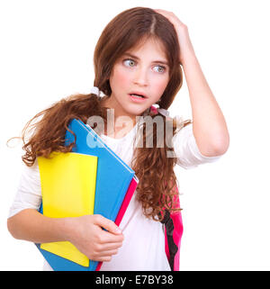 Portrait of confused school girl holding head by hand isolated on white background, didn't know answer on question Stock Photo