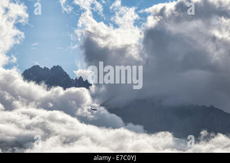 Small plane flying through big clouds in the rugged mountains of Southeast Alaska. Stock Photo