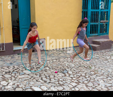 young girls playing with hula hoop, Trinidad, Cuba Stock Photo