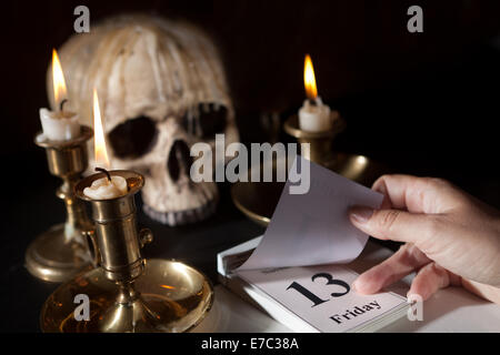 Friday 13th on a calendar with candles and a creepy skull Stock Photo