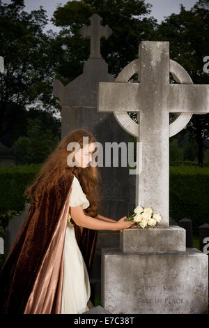 Victorian scene of a mourning lady at a tombstone (text on tombstone has been replaced) Stock Photo