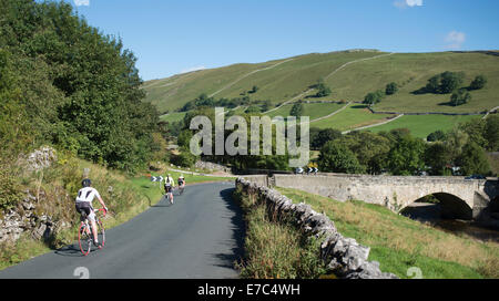 Cyclists descending into Kettlewell, Yorkshire Dales national park Stock Photo
