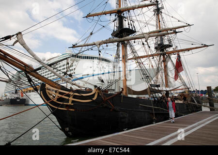 Tall ship Phoenix docks in front of the adventure of the seas cruise ship at the Southampton boat show 2014 Stock Photo