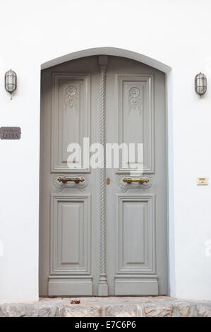 The door to a house in Hydra, Greece, showing traditional design elements. Stock Photo