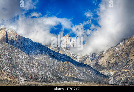 The peak of Mount Whitney as it breaks through the clouds. Highest peak in the continental United States. Stock Photo