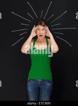 Concept of beautiful young student in panic with light  rays over the head Stock Photo