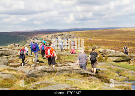 A large number of people enjoying themselves in the outdoors on Stanage Edge in the Peak District Derbyshire Stock Photo