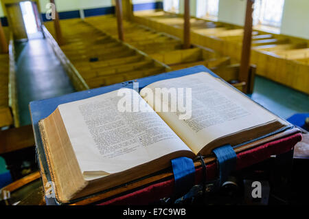 A bible sits open on the altar of a church Stock Photo