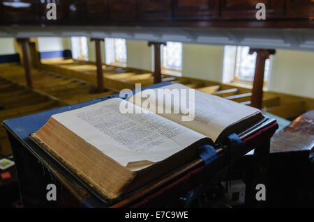 A bible sits open on the altar of a church Stock Photo