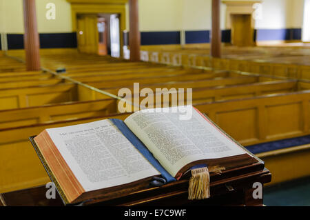 A bible sits open on the altar of a church Stock Photo