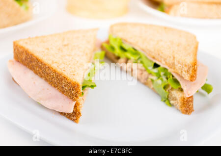 ham and lettuce sandwich on a white plate Stock Photo