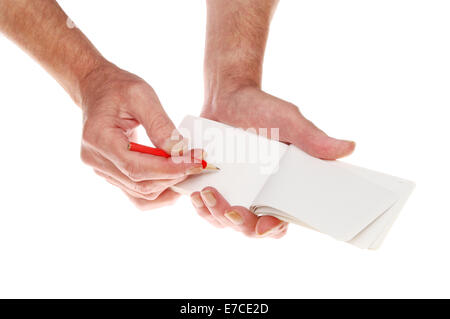 Closeup of a pair of hands writing with a pencil in a notebook Stock Photo
