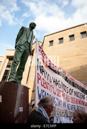 Glasgow, Scotland, UK. 13th September, 2014. The Donald Dewar statue stands tall next to Nato protesters during the lead up to the Scottish independence referendum on Buchanan Street, Glasgow, Scotland on Saturday 13th September 2014 Credit:  Iona Shepherd/Alamy Live News Stock Photo