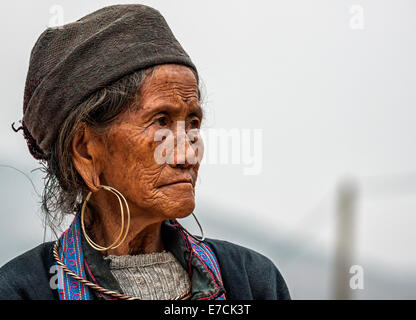 Close up of Hmong elderly woman against gray skies. Stock Photo